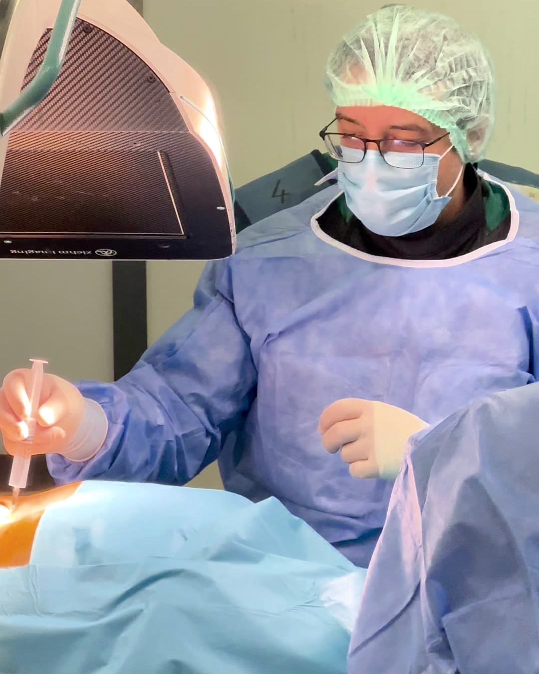 Op. Dr. Enis Gürsel skopi altında iğne yerleştirirken